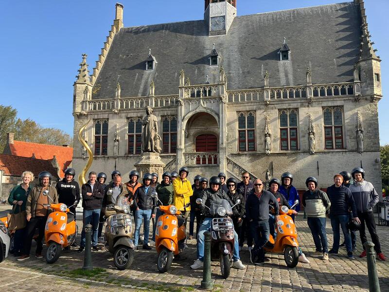 Group on scooters in front of a castle during an incentive