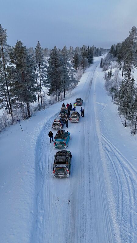 Snowmobiles on a snowy forest track during the Carbage Run