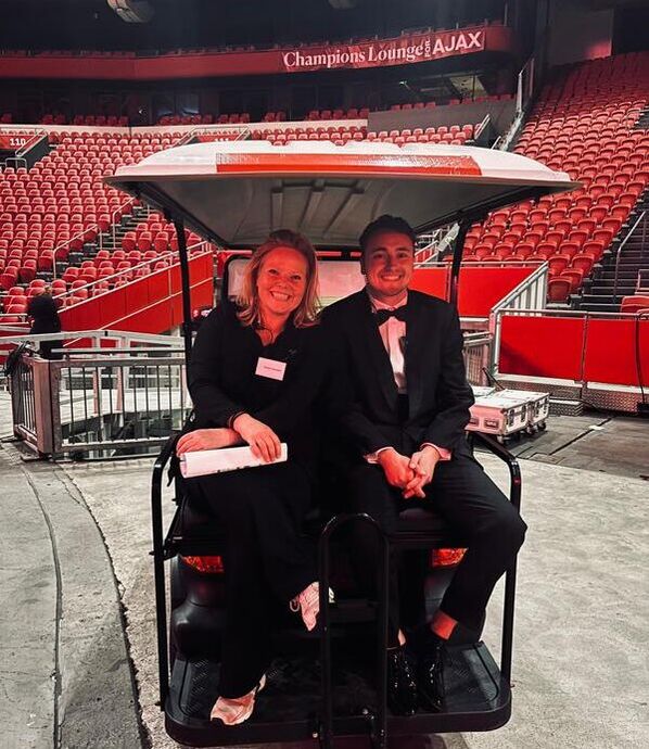 Susan and a colleague on a golf cart at the Johan Cruijff ArenA